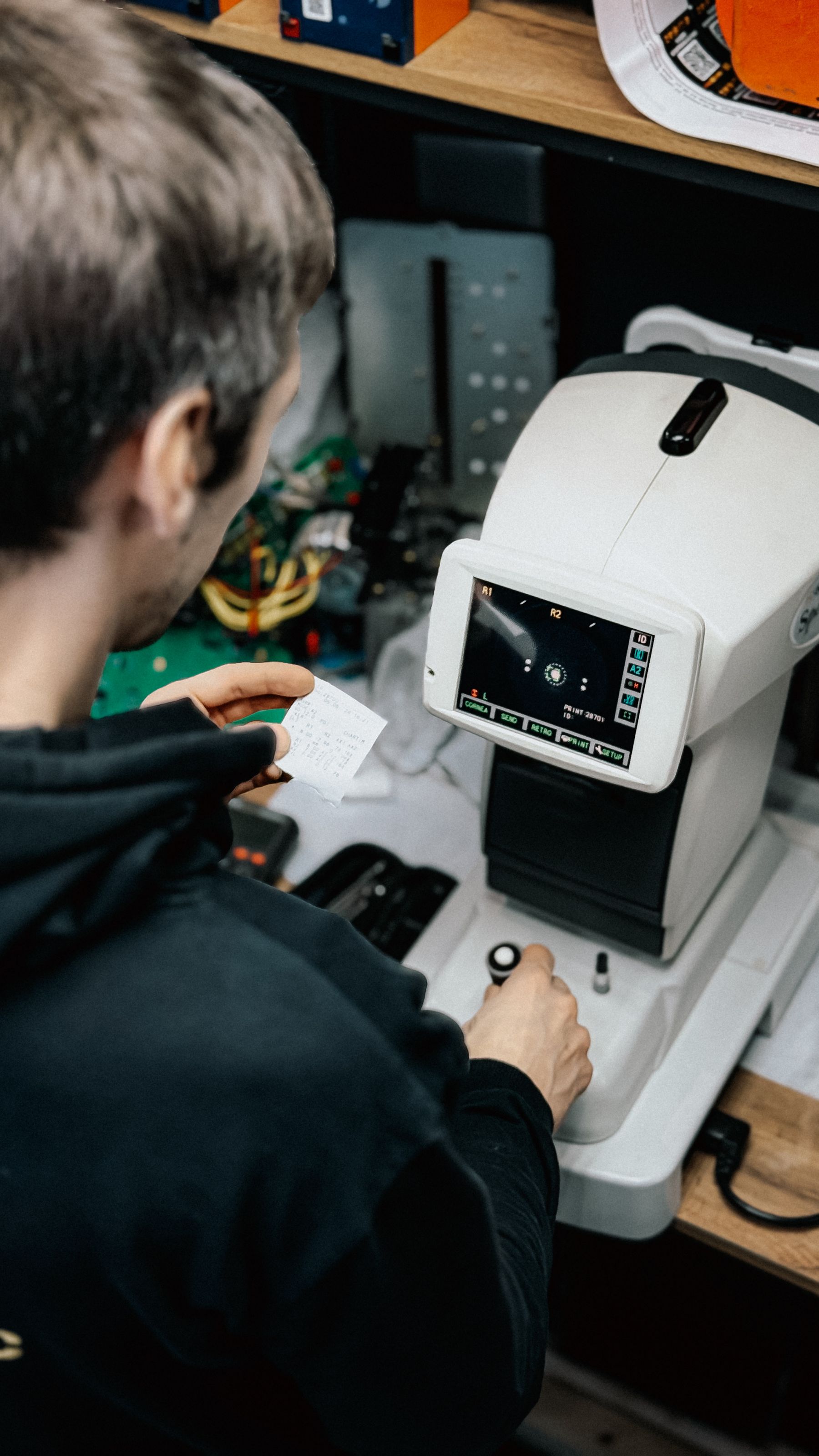 A technician operating an optical measurement instrument